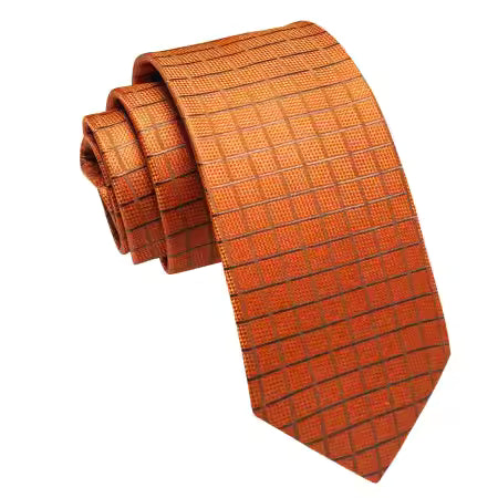 Orange copper grid pattern silk tie rolled flat, showing detailed weave and pattern on a white background