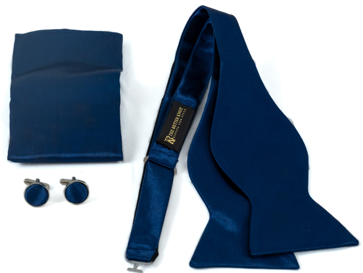 Self-tie Navy Blue silk bow tie set for men, includes adjustable bow tie, 8.5-inch matching pocket square, and cufflinks in a gift box. Elegant accessory for formal events or gift-giving.