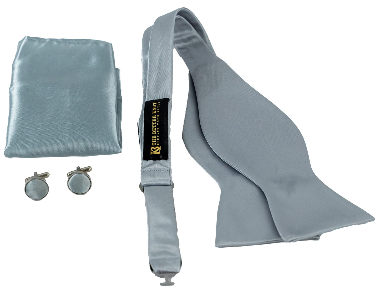 Self-tie Silver silk bow tie set for men, includes adjustable bow tie, 8.5-inch matching pocket square, and cufflinks in a gift box. Elegant accessory for formal events or gift-giving.