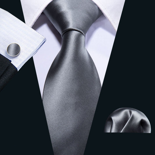 "Premium silk tie set in Solid Gray, including a matching pocket square and cufflinks. Sophisticated and versatile for any occasion. Crafted for timeless elegance."