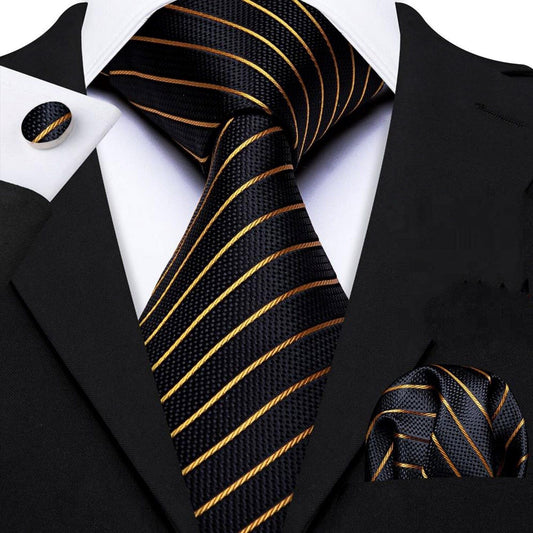 "Premium silk tie set in Black with Gold Diagonal Lines, including a matching pocket square and cufflinks. Sophisticated and versatile for any occasion. Crafted for timeless elegance."