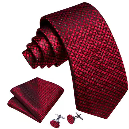 Burgundy-red geometric silk tie set with matching pocket square and  cufflinks displayed together on a white background.”