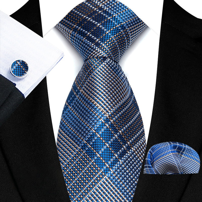 This Gray and Blue Diagonal Pattern Tie Set is perfect for any formal occasion. The set includes a modern tie, matching cufflinks, and a pocket square, adding a touch of sophistication to any outfit. The texture of the tie gives it a luxurious feel while the subtle blue and gray diagonal pattern adds a touch of elegance. Elevate your style with this set.