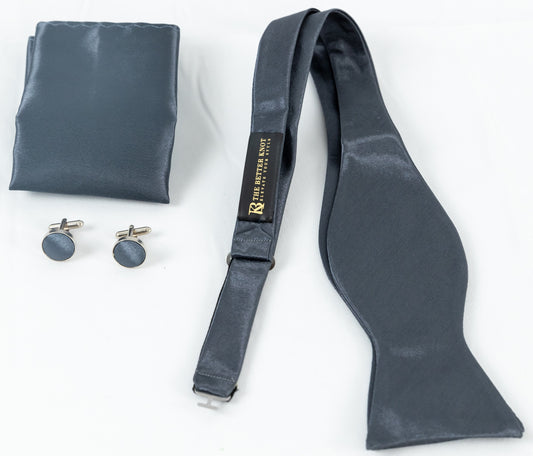 Self-tie Dark Gray silk bow tie set for men, includes adjustable bow tie, 8.5-inch matching pocket square, and cufflinks in a gift box. Elegant accessory for formal events or gift-giving.