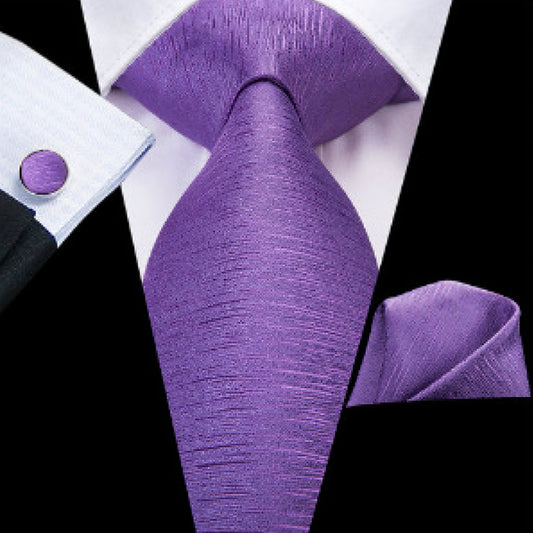 "Premium silk tie set in Solid Purple, including a matching pocket square and cufflinks. Sophisticated and versatile for any occasion. Crafted for timeless elegance."